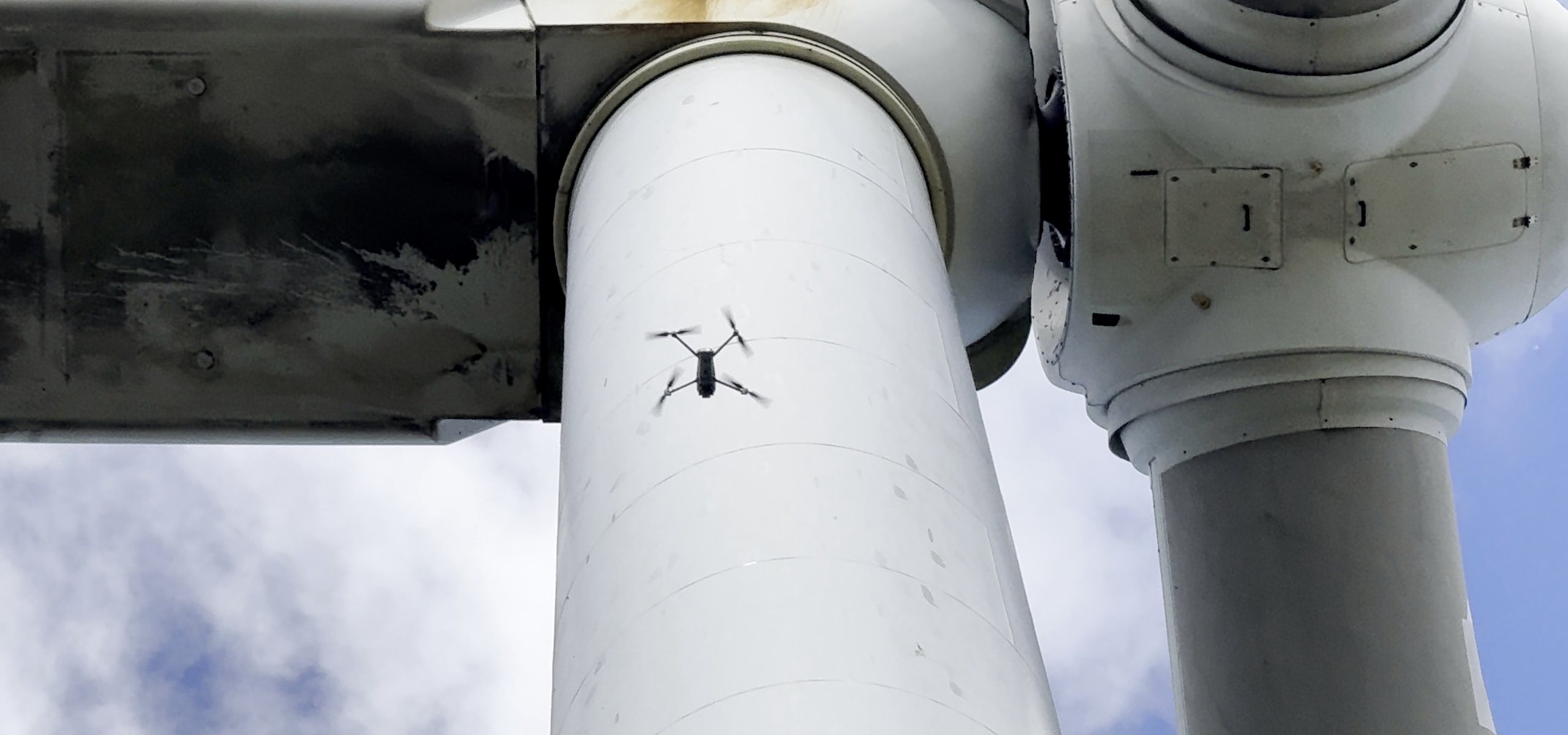 RPAS in flight beside a wind turbine tower